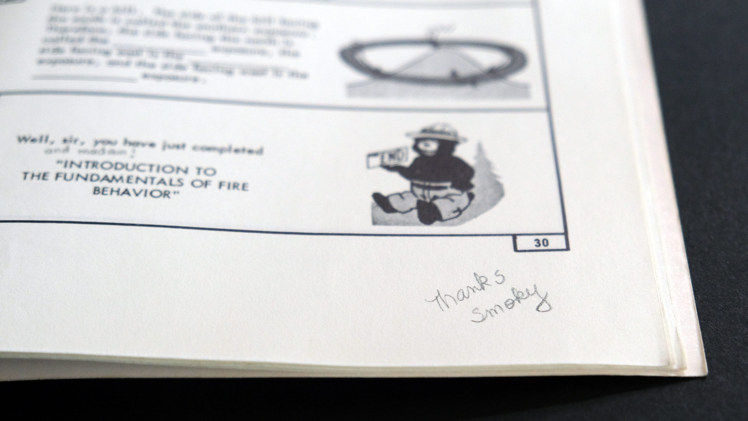 Evidence of someone's gratitude for Smokey Bear shows up in warm cursive writing inside Introduction to the Fundamentals of Fire Behavior: Programed Learning, A Powerful New Training Tool by the US Forest Service (1960s)
